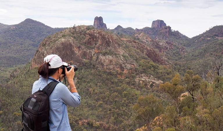  A bushwalker photographs the Warrumbungle Range from the top of Fans Horizon walking track. Photo: Leah Pippos &copy; OEH