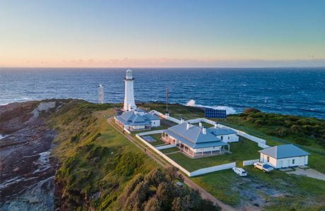 An aerial view of Green Cape Lighthouse  at dusk in Beowa National Park with the ocean in the background. Credit: Jessica Taunton / DCCEEW &copy; Jessica Taunton