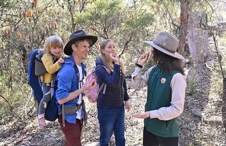 A family enjoying a guided tour led by an NPWS ranger. Photo: Adam Hollingworth © DCCEEW