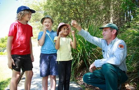 Two children and a ranger on a discovery tour. Photo: Rosie Nicolai/DCCEEW &copy; DPE