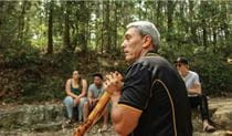 Aboriginal guide playing didgerdoo in Glenrock State Conservation Area. Photo: Amos Simon &copy; Muurung Marai