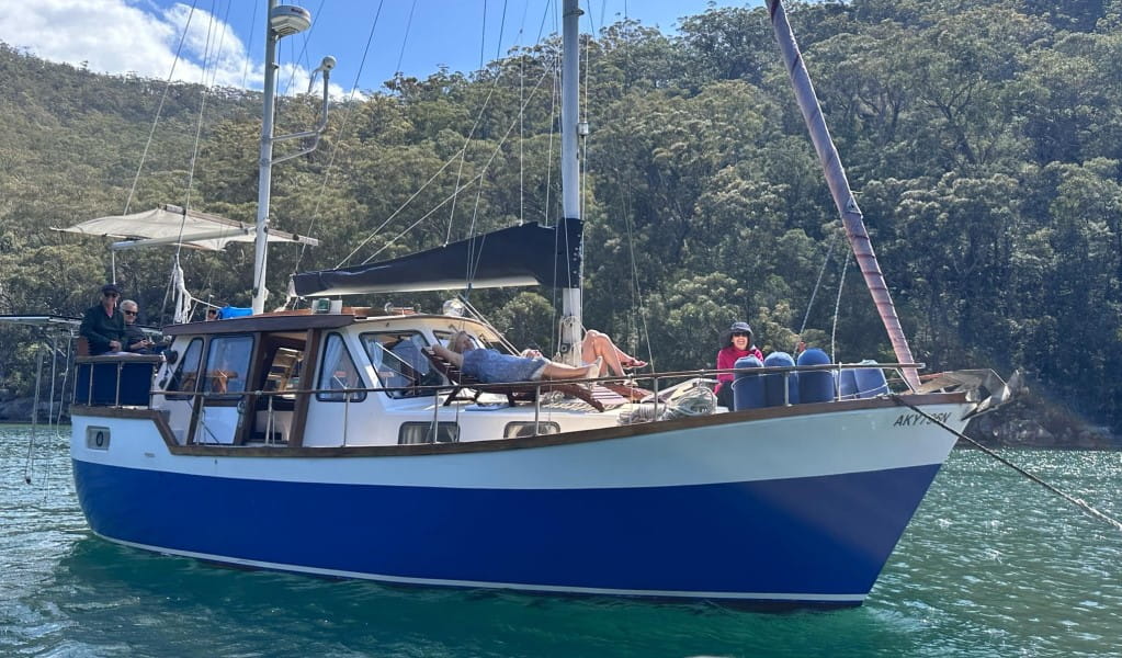 A group of people relaxing on a private boat tour with Refuge Bay Charters in Ku-ring-gai Chase National Park. Photo: Nicholas Baillie Jackson &copy; Refuge Bay Charters