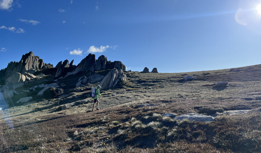 Hiker walking up a rocky slope. Photo: Madison Wait &copy; The Adventure Gene