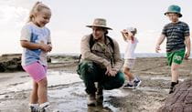 NPWS Ranger with 3 children in Glenrock National Park. Photo: Zain Kruyer &copy; DCCEEW