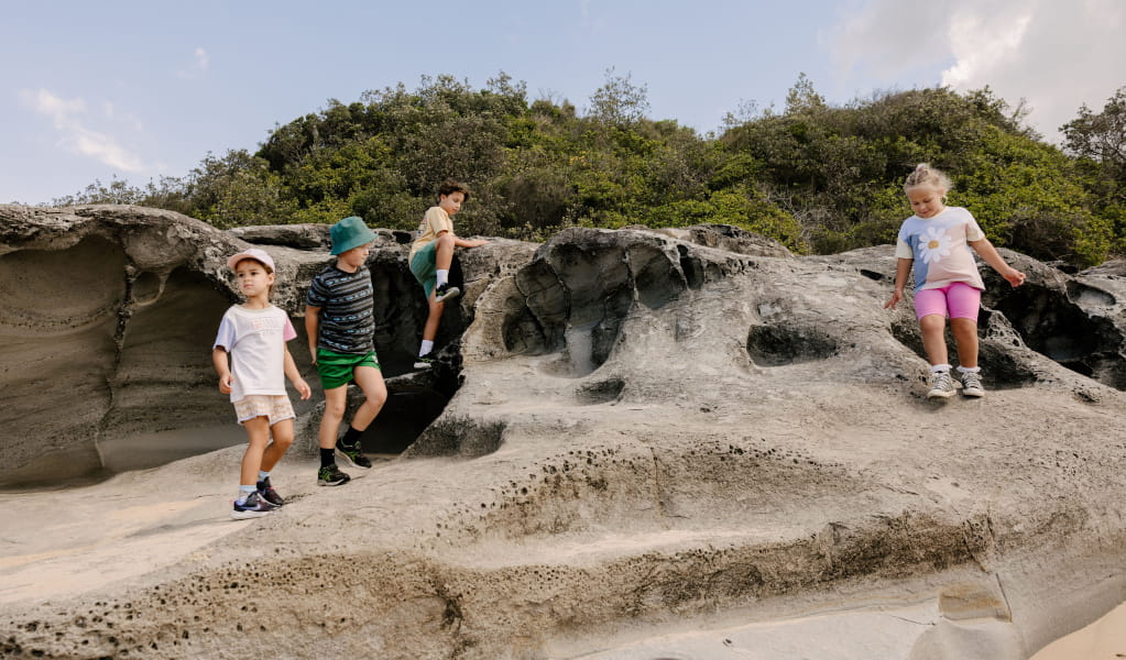 A group of young children playing on rocks. Photo: Zain Kruyer &copy; DCCEEW