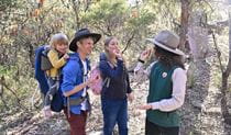 A family enjoying a guided tour led by an NPWS ranger. Credit: Adam Hollingworth &copy; DCCEEW 