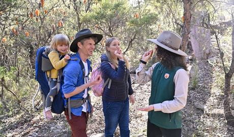 A family on a guided tour talks with an NPWS ranger wile on a guided tour. Credit: Adam Hollingworth &copy; DCCEEW 