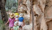 An NPWS guide leads children along Sandstone Caves walking track, Pilliga Nature Reserve. Photo: John Spencer &copy;DPIE