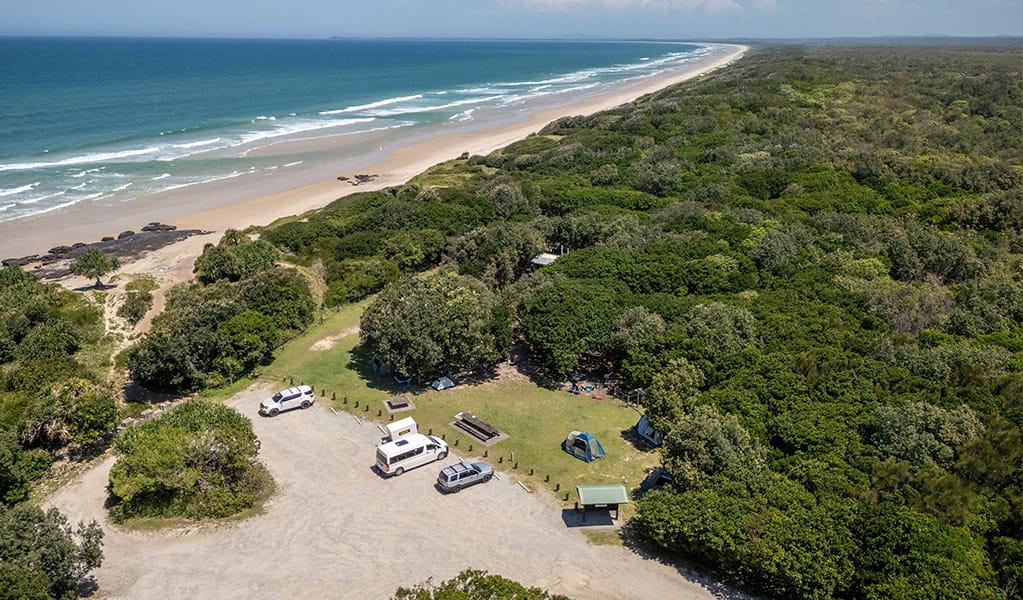 Aerial view of the carpark, campground and beach at Mibanbah-Black Rocks campground. Credit: John Spencer &copy; DCCEEW