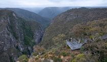 Aerial view of Adams lookout, with 2 people admiring the view over dramatic gorges, Bungonia National Park. Photo: John Spencer/DCCEEW