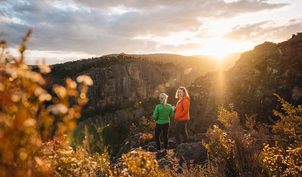 2 hikers looking out at views over Carne Creek at sunrise in Gardens of Stone State Conservation Area. Credit: Harrison Candlin &copy; Harrison Candlin