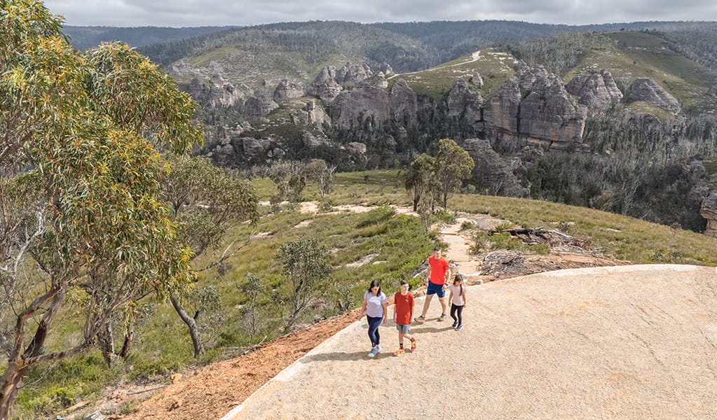 An aerial shot of a family walking around Lost City lookout in Gardens of Stone State Conservation Area with pagodas in the background. Credit: Simone Cottrell &copy; DCCEEW