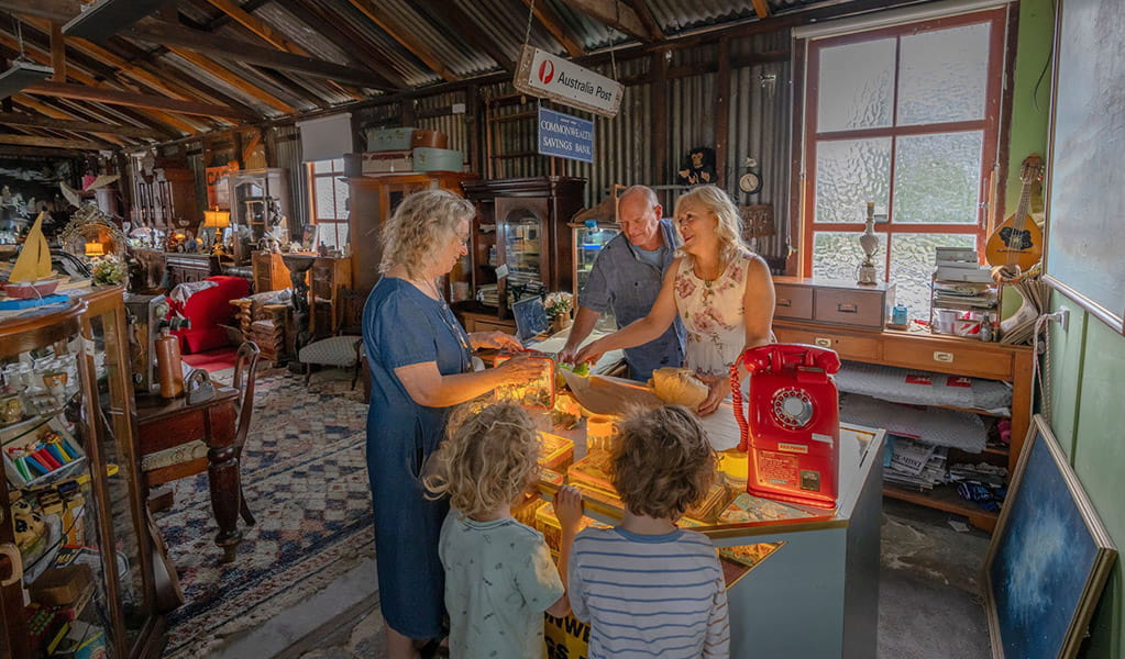 Shoppers at the counter of Gold Rush Antiques inside the old Corneys Garage, Hartley Historic Site. Credit: John Spencer &copy; DCCEEW