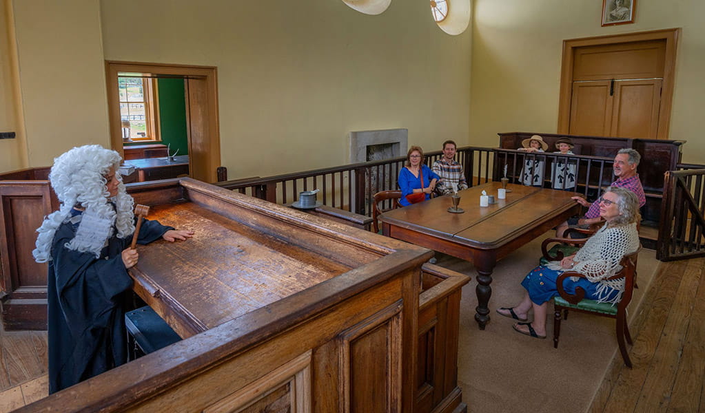 A child dressed as a judge on the judges bench pretending to address visitors inside Hartley Courthouse. Credit: John Spencer &copy; DCCEEW