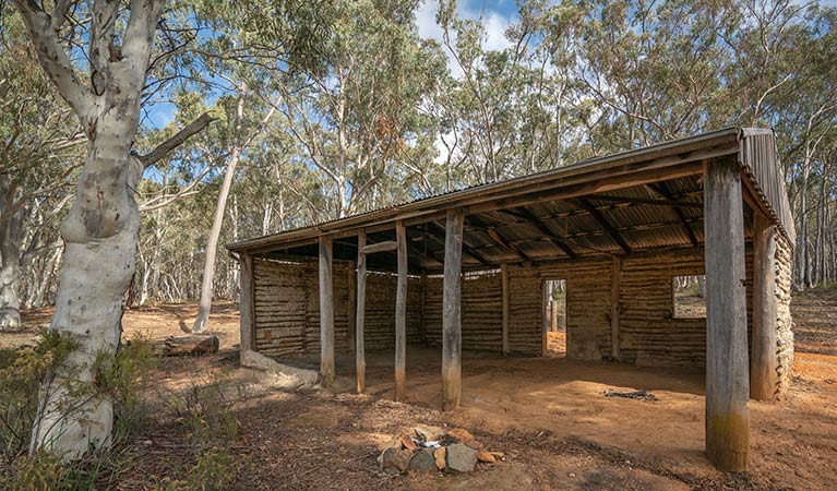 A large wooden shelter with a red dirt floor at Glendora campground in Hill End Historic Site. Photo: John Spencer/OEH