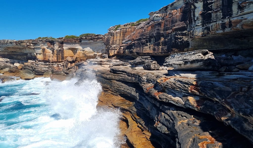 Waves crash up to Skylight cave and its entrance at most tides, Kurnell area, Kamay Botany Bay National Park. Photo: Jeremy Malgras &copy; DCCEEW