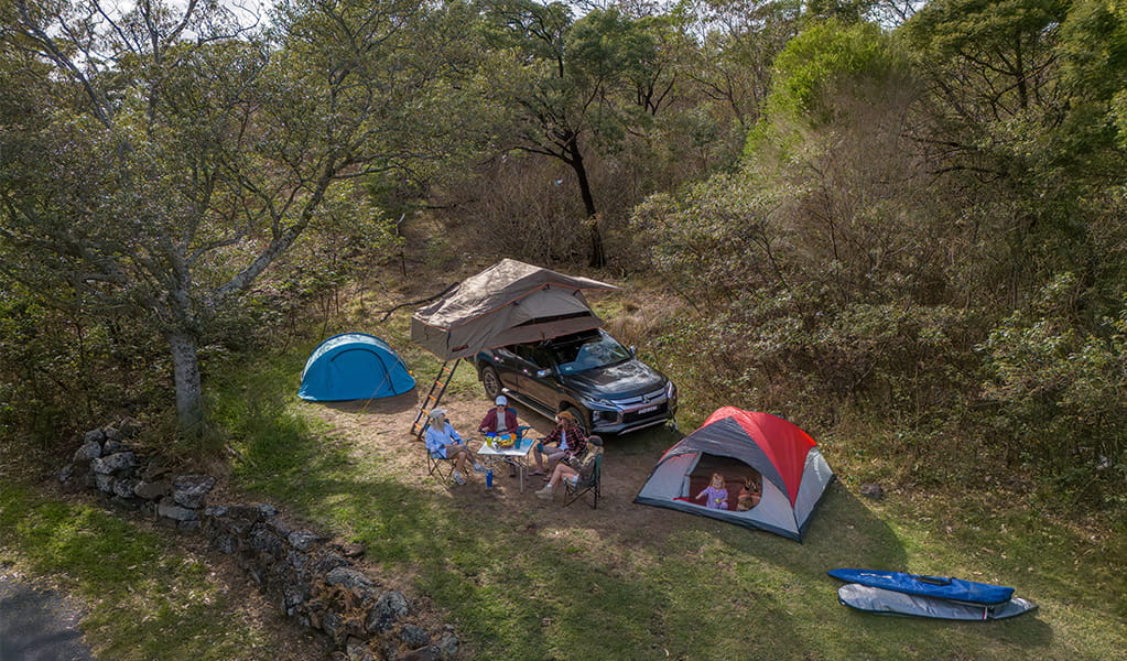 A family camping with a camper trailer at Killalea campground. Photo: John Spencer/DCCEEW &copy; DCCEEW