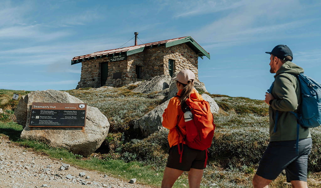 2 hikers walking to Seamans Hut on Main Range walk in the Thredbo-Perisher area of Kosciuszko National Park. Credit: Remy Brand / DCCEEW &copy; Caravel Content