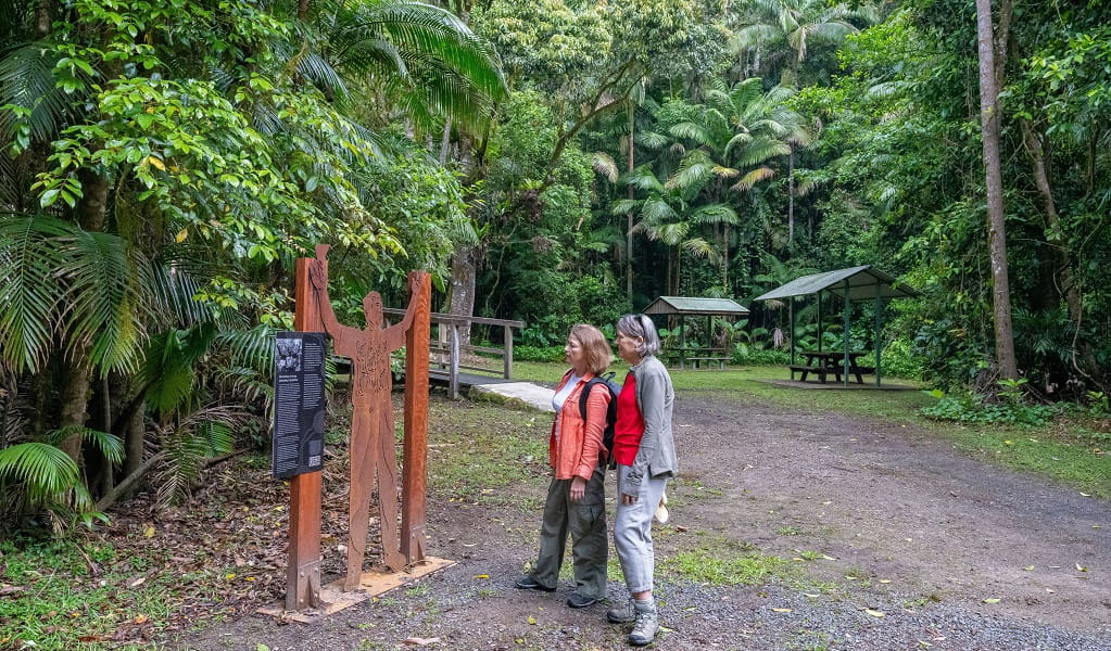 Visitors stop to admire a metal sculpture of Murray John Roberts, who was an Aboriginal elder, conservation protestor and strong protector of his Country, Terania Creek picnic area, Nightcap National Park. Photo: John Spencer/DCCEEW 