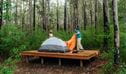 Campers setting up their tent on the timber tent platform at Weeun Weeun campground. Photo: Remy Brand &copy; Caravel Content 