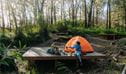 Campers enjoying  a cuppa on the wooden camping platform at Yelgun Kyoomgun campground. Photo: Remy Brand &copy; Caravel Content