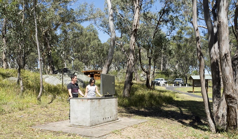 Two people at the barbecue, Threlfall picnic area, Oxley Wild Rivers National Park. Photo: Leah Pippos &copy;DPIE