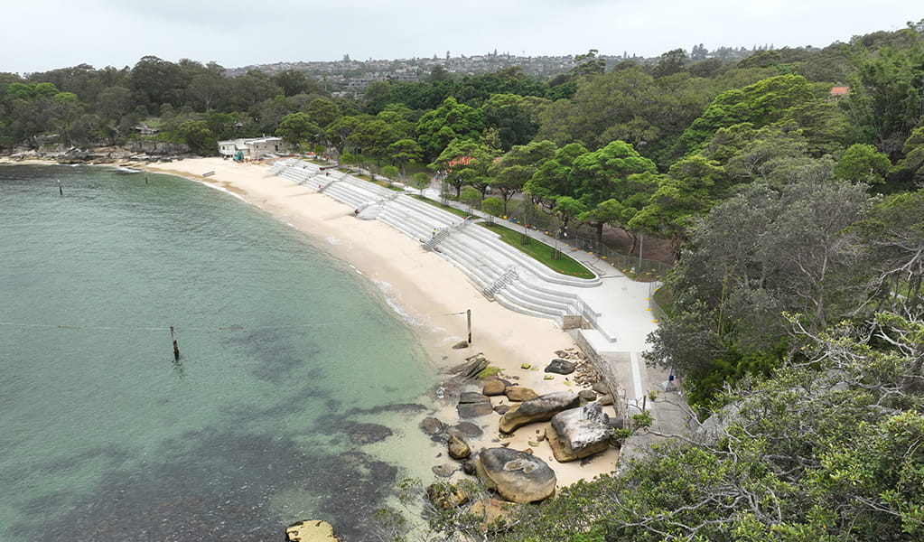 Aerial photo of Nielsen Park showing the concrete seawall and Shark Beach and bordering lush green parkland. Credit: Drew Elliott/DCCEEW &copy; DCCEEW 