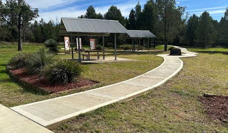 A paved path leading to picnic shelters at Terry Hie Hie picnic area. Credit: DCCEEW &copy; DCCEEW