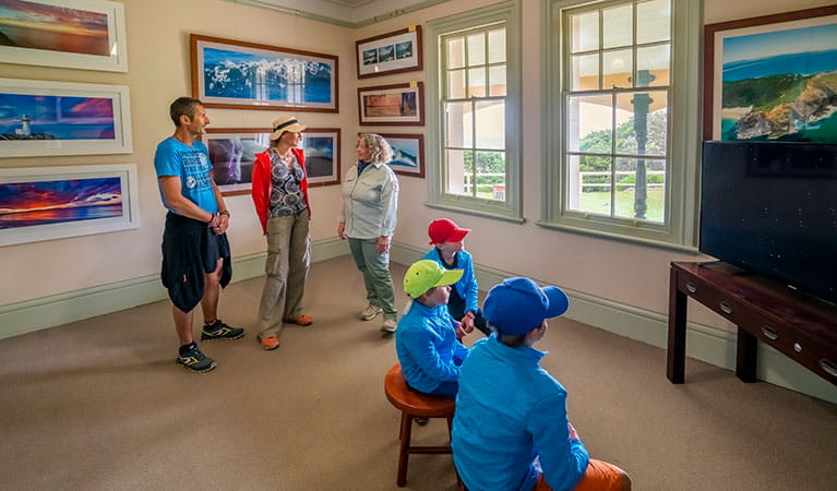 Visitors to Cape Byron Information Centre talking to an NPWS staff member in Walgun Cape Byron State Conservation Area. Photo: John Spencer/DPIE