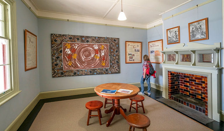 A woman viewing artwork at Cape Byron Information Centre in Walgun Cape Byron State Conservation Area. Photo: John Spencer/DPIE