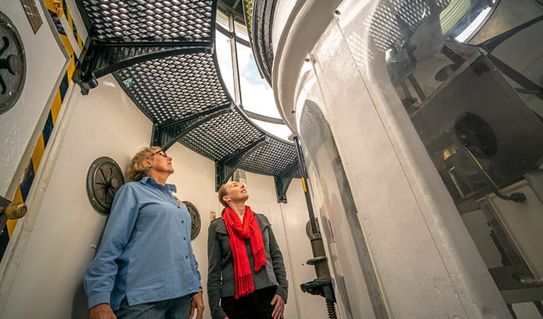 Two women in the tower of Cape Byron Lighthouse, Walgun Cape Byron State Conservation Area. Photo: John Spencer/OEH.