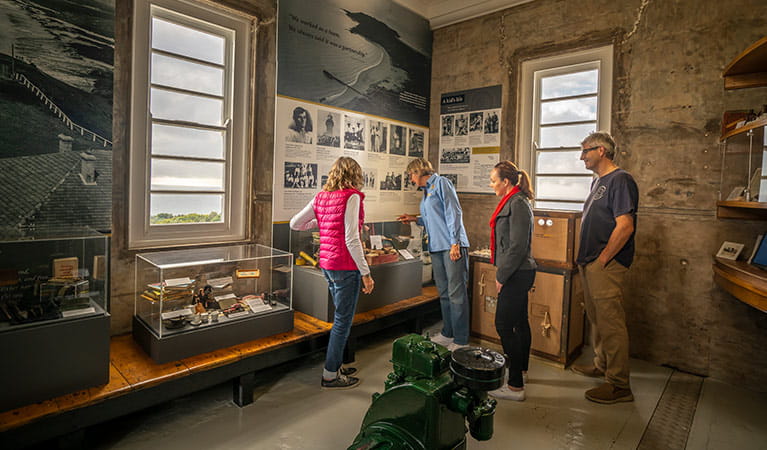 A tour group look at history displays in Cape Byron Lighthouse, Walgun Cape Byron State Conservation Area. Photo: John Spencer/DCCEEW.