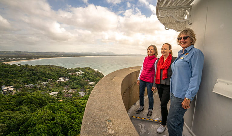 Three women enjoy views from the top of Cape Byron Lighthouse, Walgun Cape Byron State Conservation Area. Photo: John Spencer/DCCEEW.