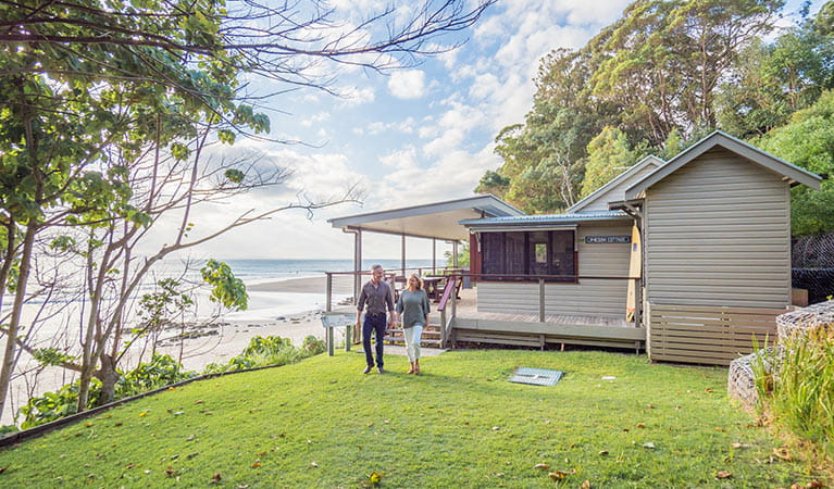 Couple walking on the lawn at Imeson Cottage. Photo: Sera Wright/DPIE.