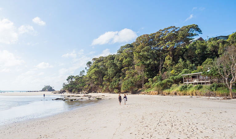 Friends walking on the beach in front of Imeson Cottage. Photo: Sera Wright/DPIE.