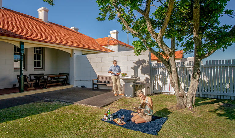 Couple having a picnic barbecue on the lawn of the Assistant Lighthouse Keepers Cottage. John Spencer/DPIE