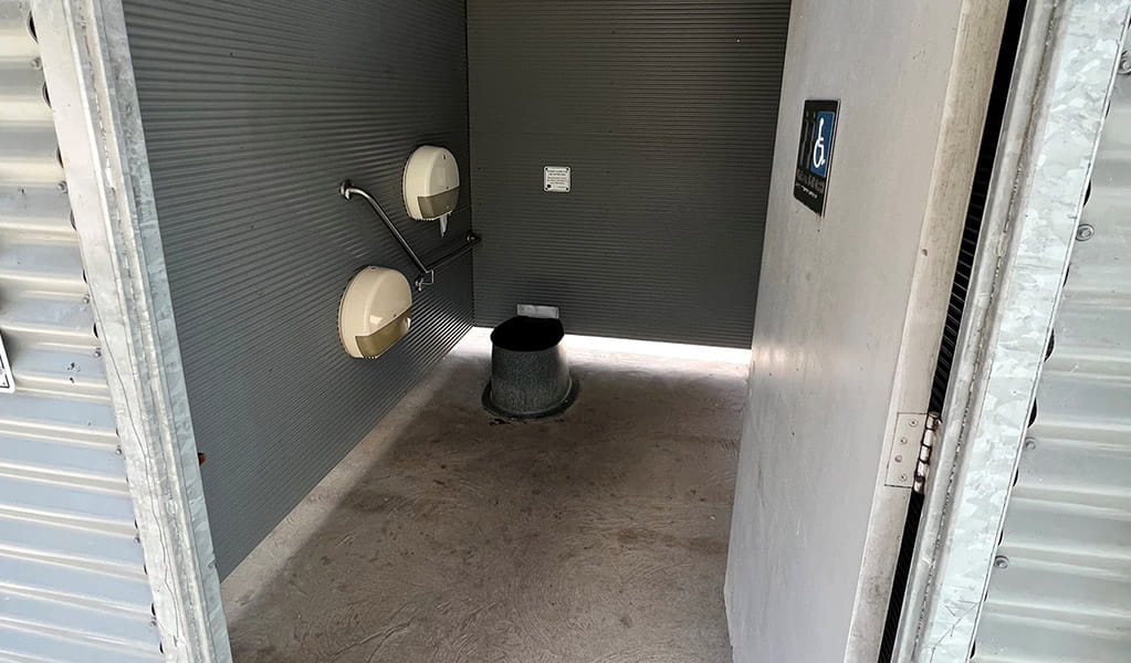 Interior view of the non-flush toilet with handrail at Coorongooba campground. Credit: &copy; DCCEEW