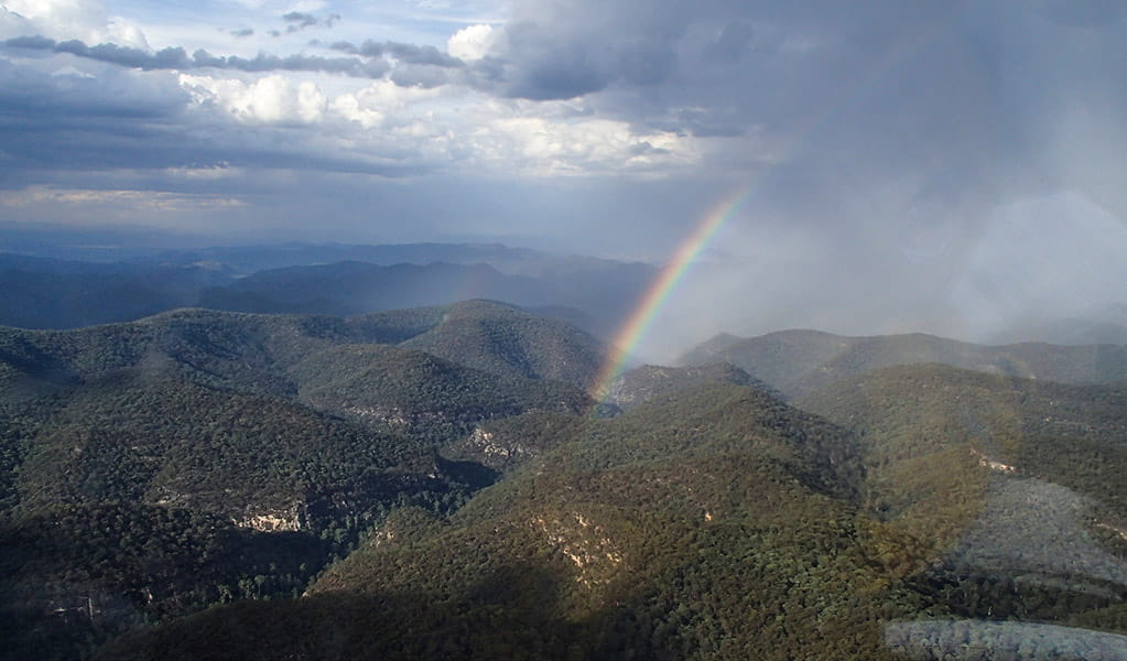  rainbow shining over the mountains in the Martindale Creek area of Wollemi National Park. Credit: David Croft &copy; DCCEEW