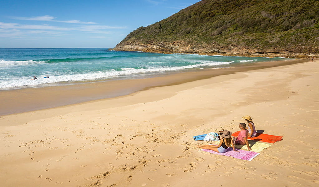 People relaxing on the sand at Seven Mile Beach. Photo: John Spencer/DCCEEW &copy; DCCEEW